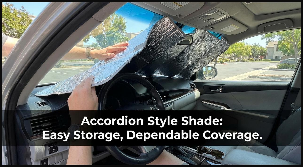 An accordion-style foldable sun shade partially open on a car windshield, with hands demonstrating its easy deployment.